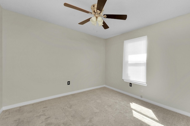 carpeted spare room with ceiling fan