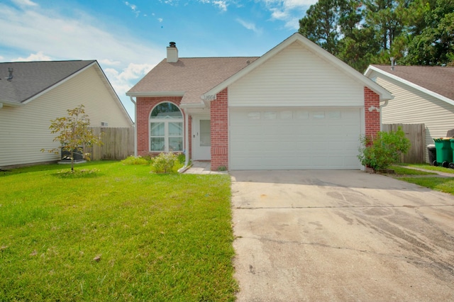 view of front of property featuring a front yard and a garage