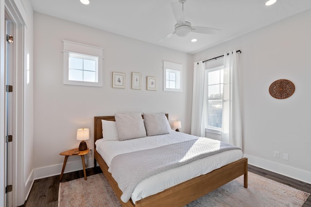 bedroom with dark hardwood / wood-style flooring and ceiling fan