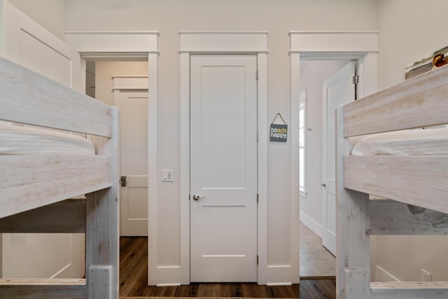 bedroom featuring dark wood-type flooring and a closet