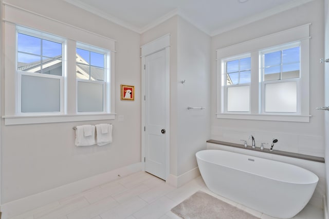 bathroom featuring tile patterned flooring, a bathtub, and ornamental molding