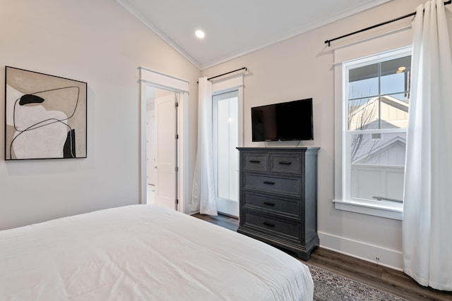 bedroom with vaulted ceiling, dark wood-type flooring, and ornamental molding