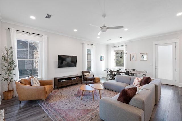 living room with ornamental molding, plenty of natural light, and dark hardwood / wood-style flooring