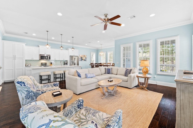 living room featuring ceiling fan, crown molding, and dark hardwood / wood-style flooring