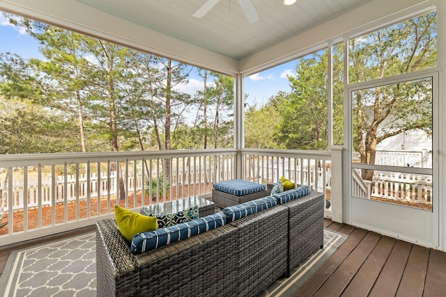 sunroom featuring ceiling fan