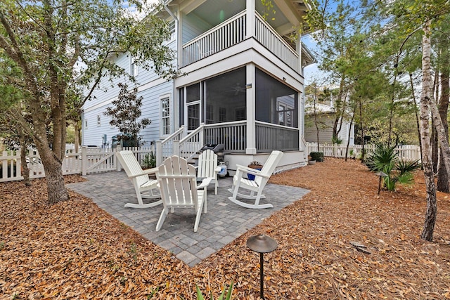 view of patio with a balcony and a sunroom