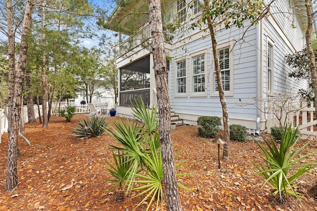 view of side of property featuring a sunroom