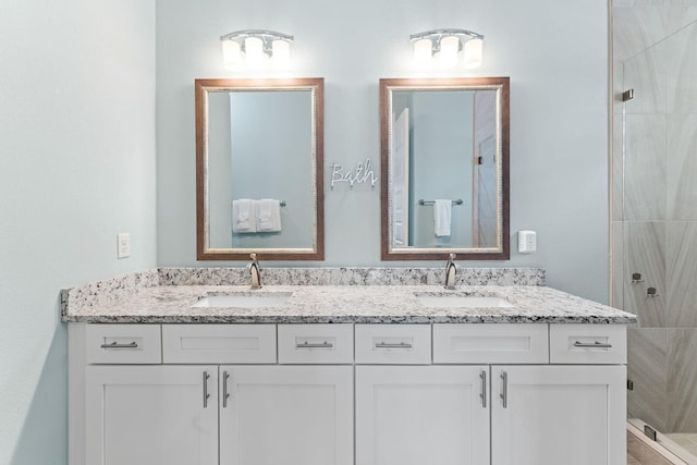 bathroom with vanity and tiled shower