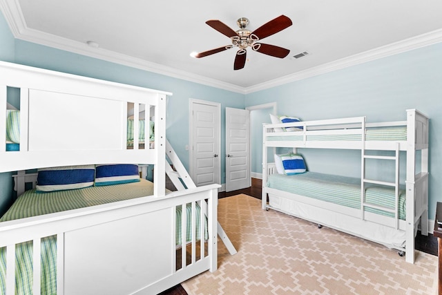 bedroom with ceiling fan and ornamental molding