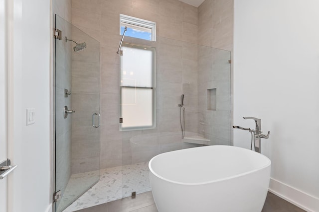 bathroom featuring shower with separate bathtub and tile patterned flooring