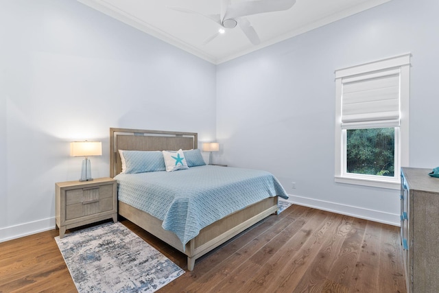 bedroom featuring ceiling fan, wood-type flooring, and ornamental molding