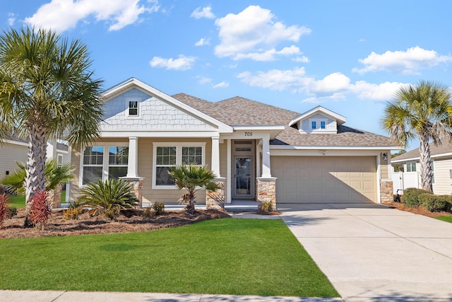 view of front of home featuring a front yard and a garage