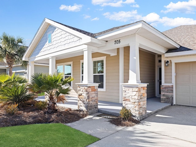 craftsman inspired home with a garage and covered porch