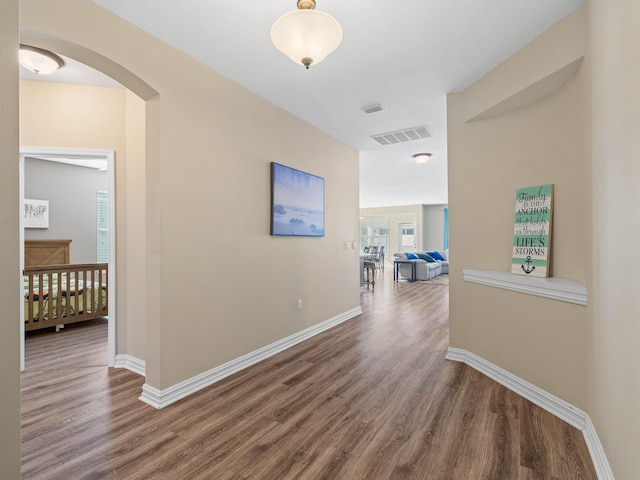 hallway with hardwood / wood-style floors