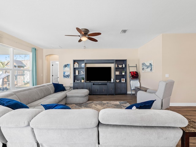 living room featuring ceiling fan and dark wood-type flooring