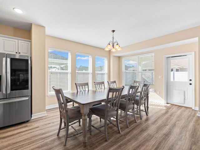 dining space featuring a notable chandelier and light hardwood / wood-style flooring