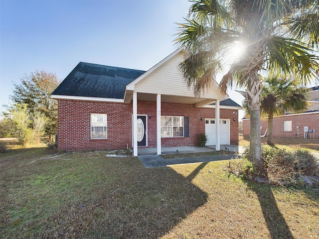 view of front of property featuring a garage and a front lawn