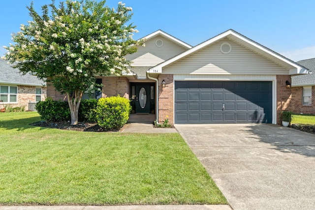 view of front of property with a garage and a front lawn