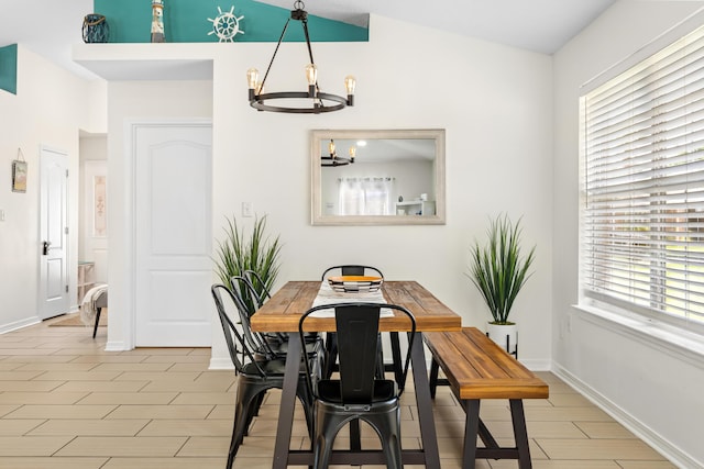 dining area with lofted ceiling, a wealth of natural light, and a chandelier