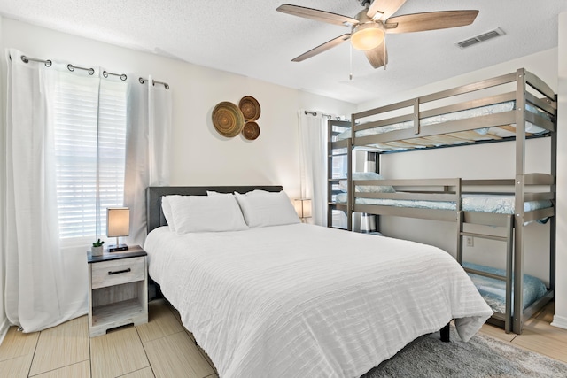 bedroom featuring a textured ceiling and ceiling fan