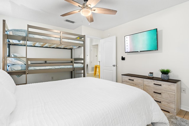 bedroom with ceiling fan and hardwood / wood-style floors