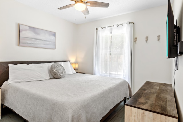 bedroom featuring multiple windows and ceiling fan