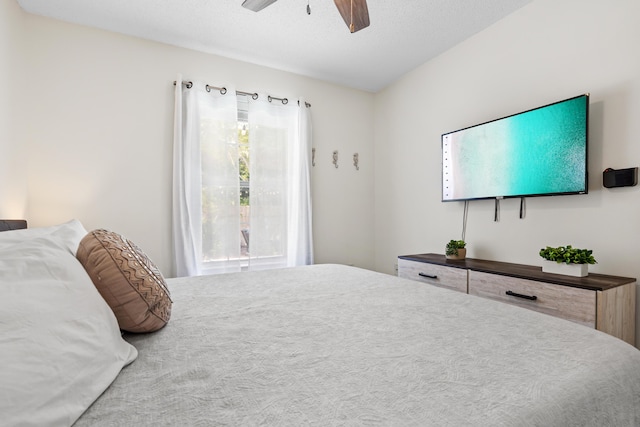 bedroom with ceiling fan and a textured ceiling