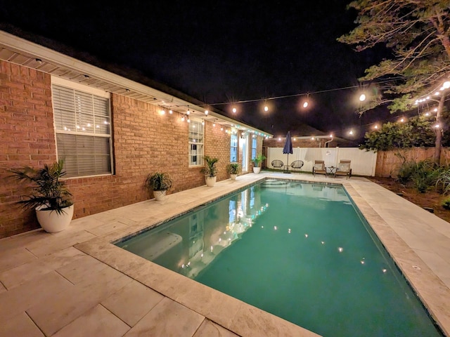 view of pool at night