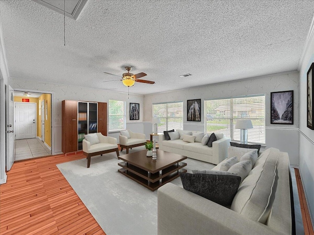 living room featuring ceiling fan and light wood-type flooring