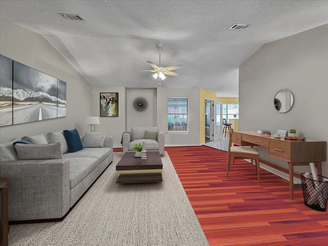 living room with a textured ceiling, ceiling fan, hardwood / wood-style floors, and vaulted ceiling