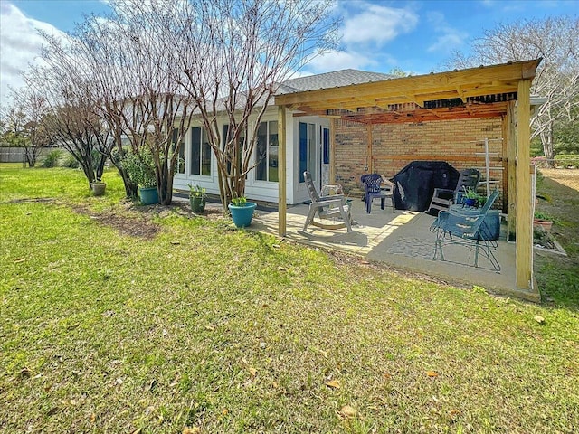 back of house with a patio area and a yard