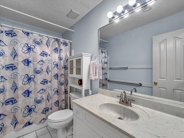 bathroom with tile patterned floors, walk in shower, vanity, a textured ceiling, and toilet