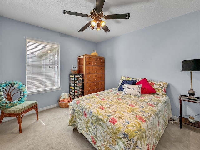 bedroom with carpet flooring, ceiling fan, and a textured ceiling