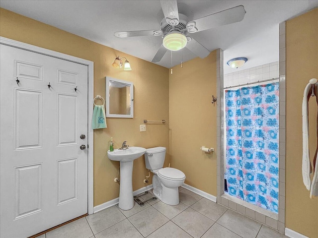 bathroom with tile patterned floors, sink, ceiling fan, toilet, and curtained shower