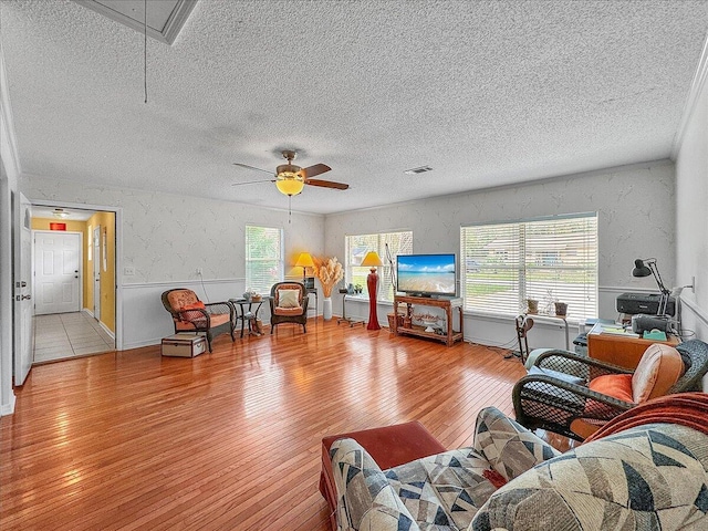 living room with ceiling fan and light wood-type flooring