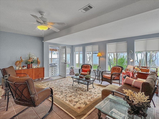 living room with ceiling fan and light tile patterned flooring