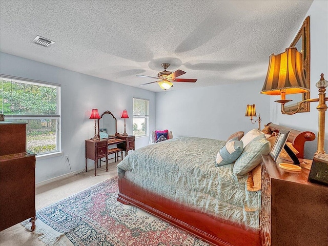 carpeted bedroom with multiple windows and ceiling fan