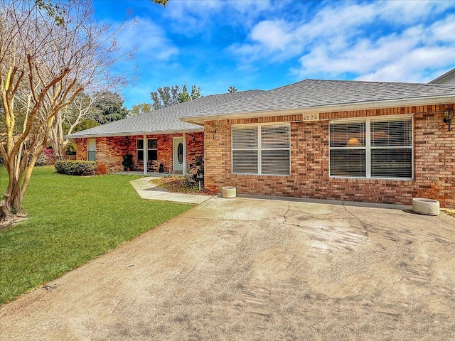 rear view of property with a lawn