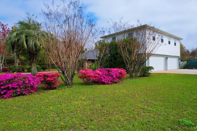 view of front of house with a garage and a front lawn