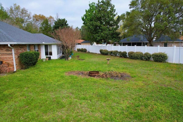 view of yard with a fire pit