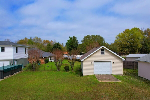 view of yard featuring an outbuilding and a garage