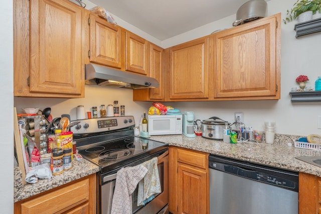 kitchen with stainless steel appliances and light stone countertops