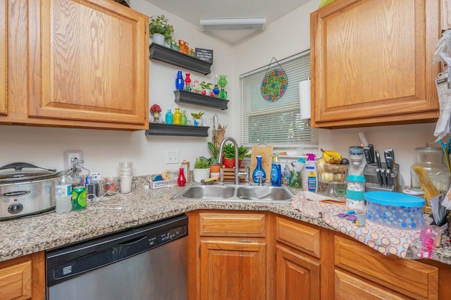 kitchen featuring light stone countertops, sink, and stainless steel dishwasher