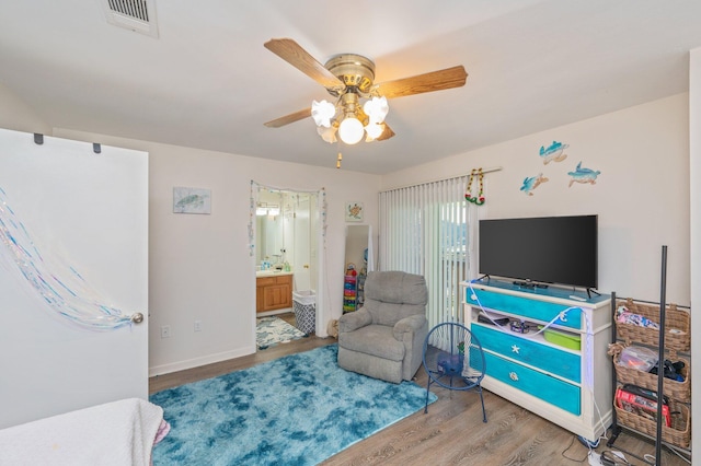 sitting room featuring ceiling fan and hardwood / wood-style flooring