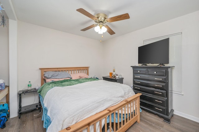 bedroom with ceiling fan and hardwood / wood-style flooring