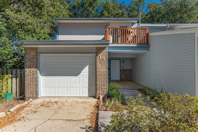 view of front of home featuring a balcony and a garage