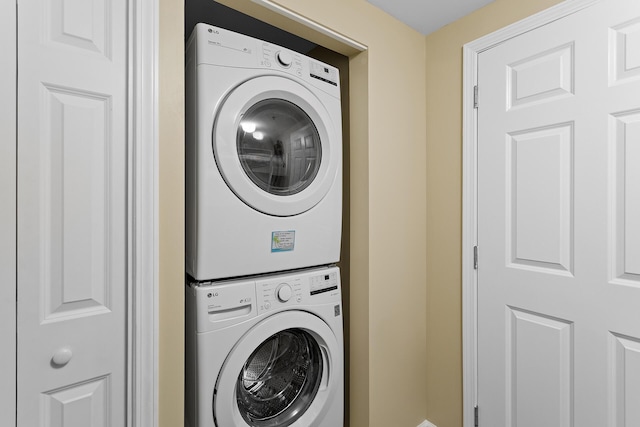 washroom with stacked washer and dryer