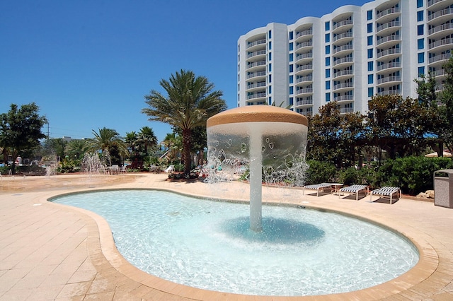 view of pool with pool water feature and a patio area