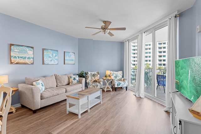 living room with ceiling fan and light wood-type flooring