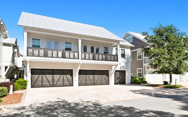 view of front of house featuring a balcony and a garage